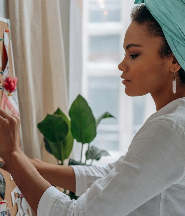 Woman in a peaceful yoga pose, surrounded by creative energy.